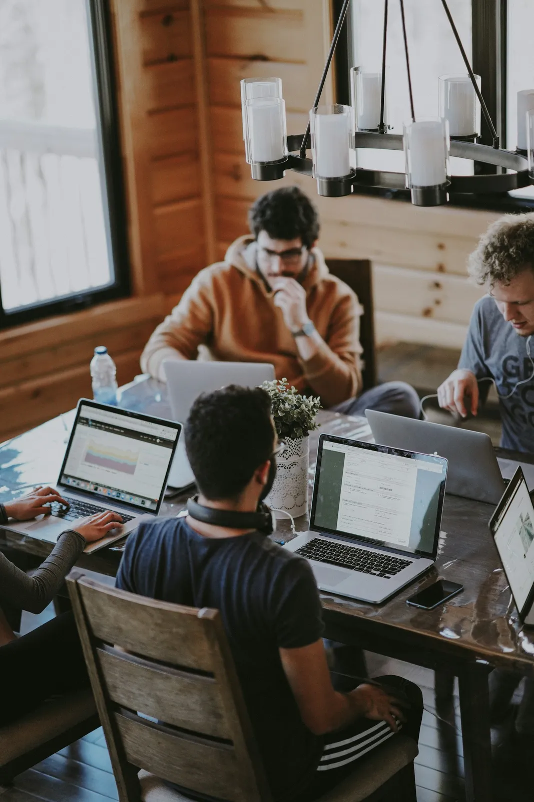 People collaborating around a work table; illustrative, not a company project or team