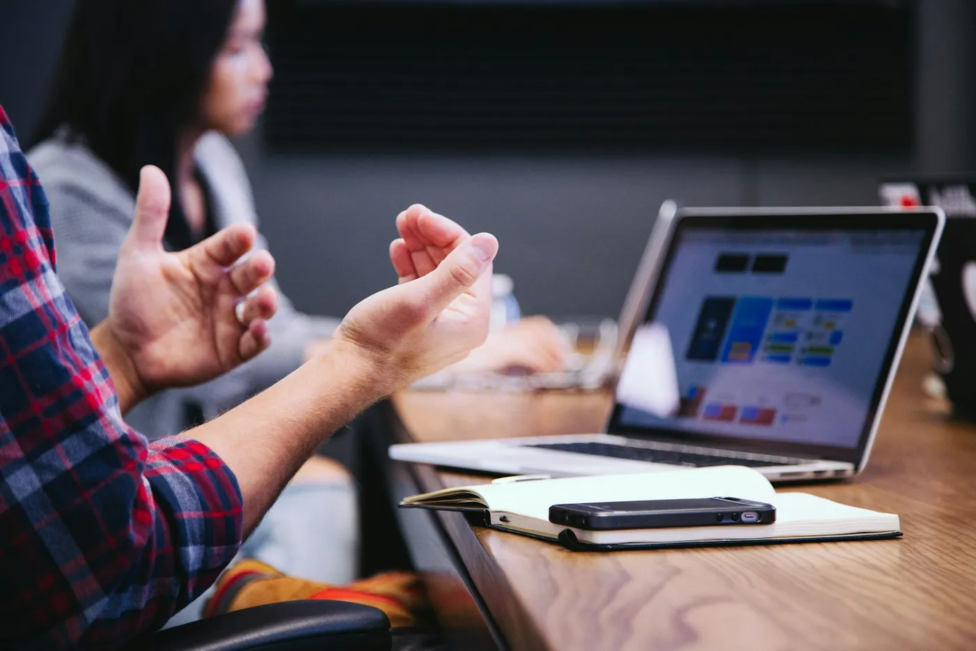 People discussing business priorities around a meeting table; illustrative photography