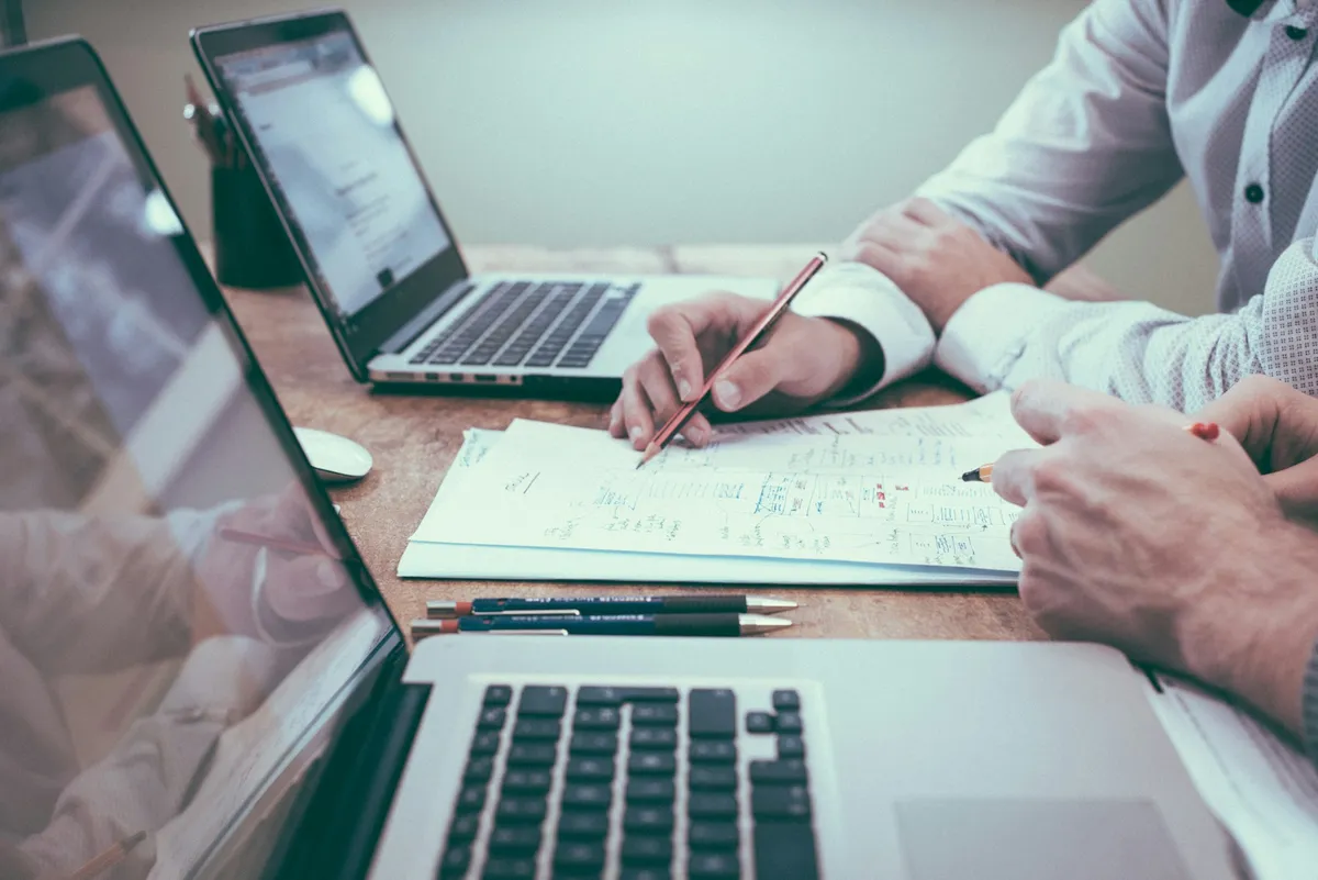 Business documents being reviewed at a table; illustrative, not a company project or team