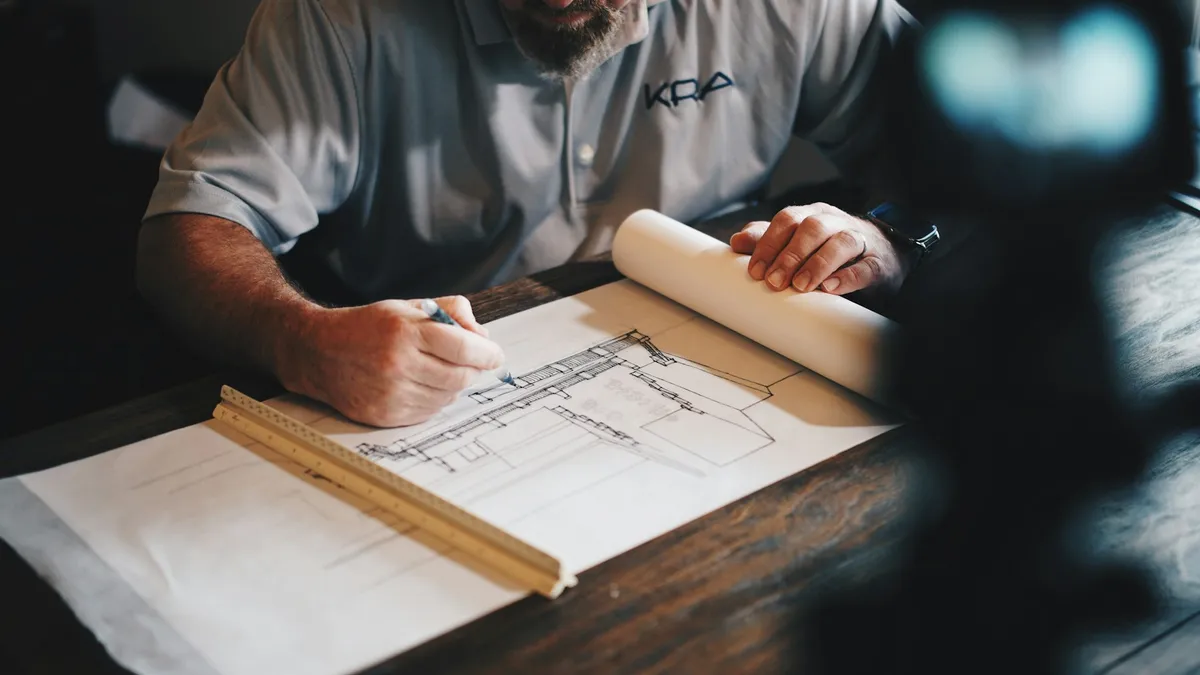 Plans and technical documents arranged for review; illustrative, not a company project or team
